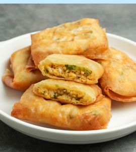 Thin martabak filled with egg batter and fresh sliced ​​spring onions forming a closed envelope.